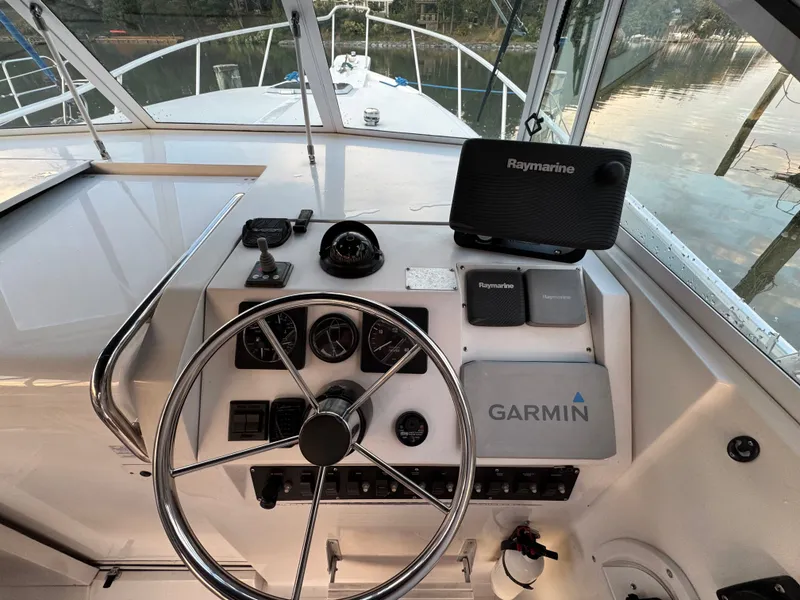 Slide: The Image of 1999 Mainship Pilot 30 Sedan helm with Garmin and Raymarine navigation systems. - 12