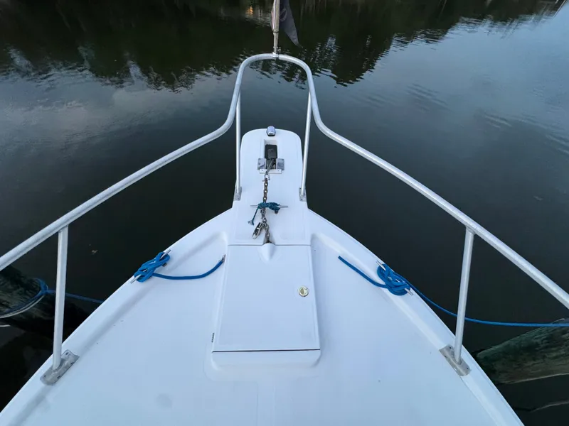 Slide: The Image of Bow of 1999 Mainship Pilot 30 Sedan boat with railing and anchor chain. - 28