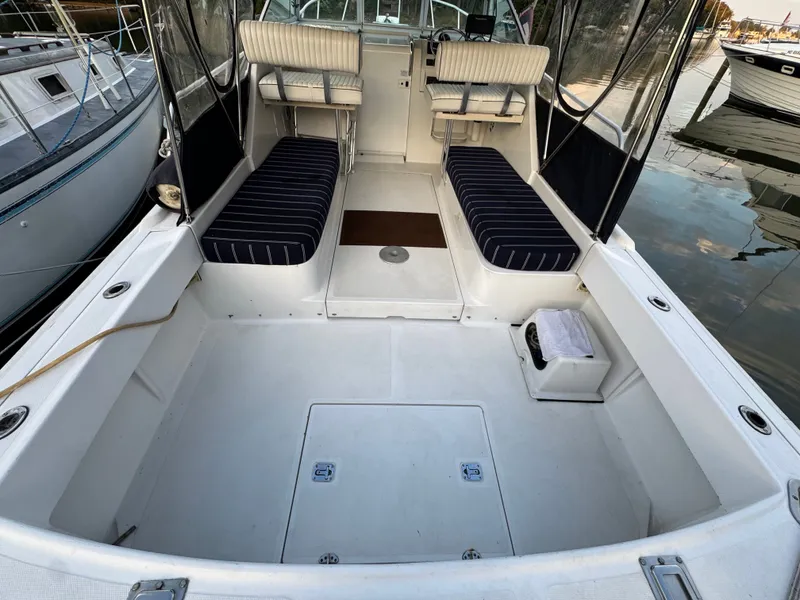 Slide: The Image of 1999 Mainship Pilot 30 Sedan boat interior with striped seating and helm station. - 5