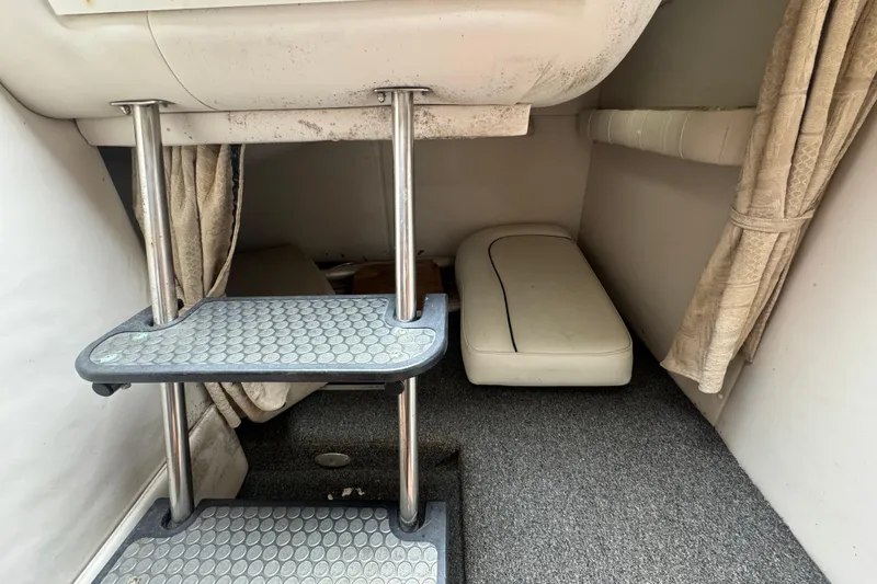 Slide: The Image of Interior cabin of 2003 Crownline 266 BR boat with steps and seating area. - 10