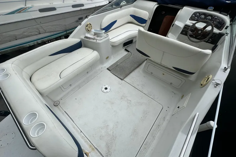 Slide: The Image of 2003 Crownline 266 BR boat interior with white seating and steering console. - 3