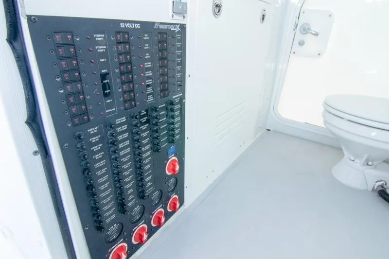 Slide: The Image of Electrical panel and toilet inside a 2022 Freeman 37 VH boat cabin. - 12