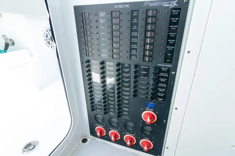 Slide: The Image of Electrical control panel of a 2022 Freeman 37 VH boat, featuring switches and dials. - 13