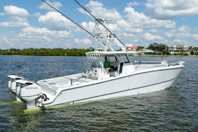 Slide: The Image of 2022 Freeman 37 VH boat on water with Suzuki engines, clear sky background. - 2