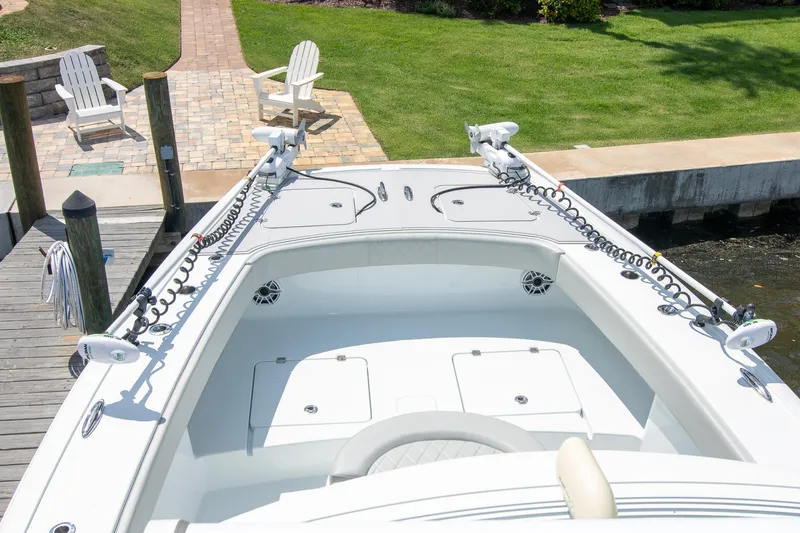 Slide: The Image of 2022 Freeman 37 VH boat docked, featuring spacious deck and dual trolling motors. - 22