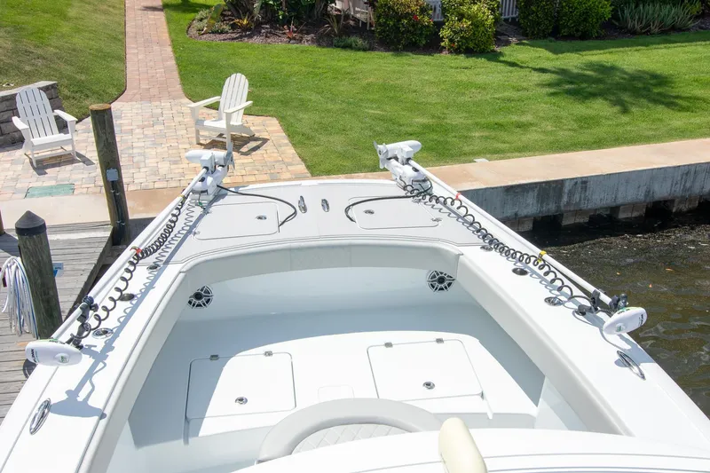 Slide: The Image of 2022 Freeman 37 VH boat docked near a grassy area with chairs. - 23