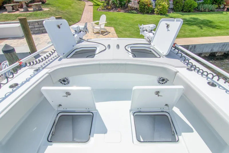 Slide: The Image of 2022 Freeman 37 VH boat deck with open storage compartments and fishing rod holders. - 24