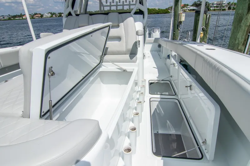 Slide: The Image of 2022 Freeman 37 VH boat interior with open storage compartments, docked by the water. - 28