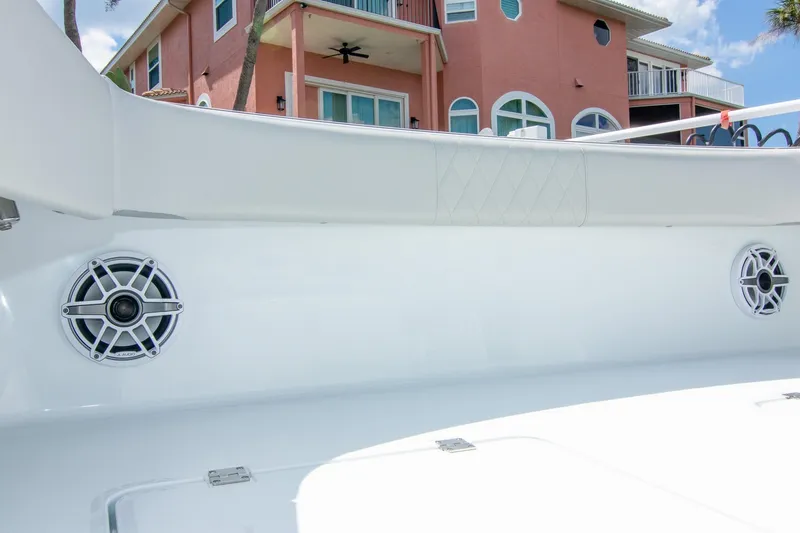 Slide: The Image of 2022 Freeman 37 VH boat interior with speakers, near a pink house. - 29