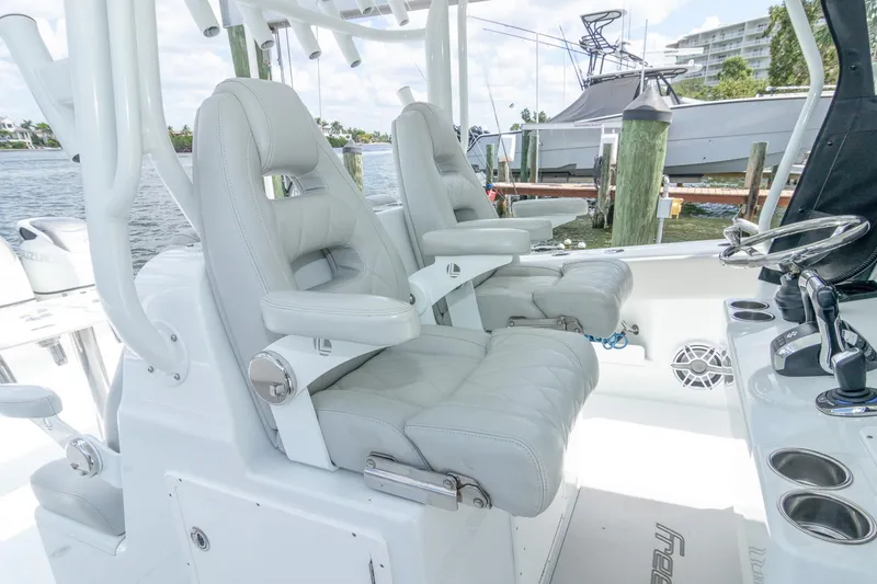 Slide: The Image of Luxury seating on 2022 Freeman 37 VH boat, featuring plush captain chairs and modern controls. - 33