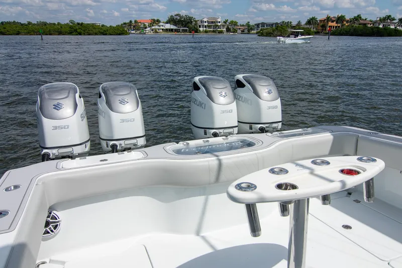 Slide: The Image of 2022 Freeman 37 VH boat with four Suzuki 350 engines on a scenic waterway. - 34