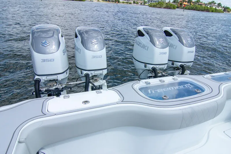 Slide: The Image of Four Suzuki 350 engines on a 2022 Freeman 37 VH boat, docked on water. - 35