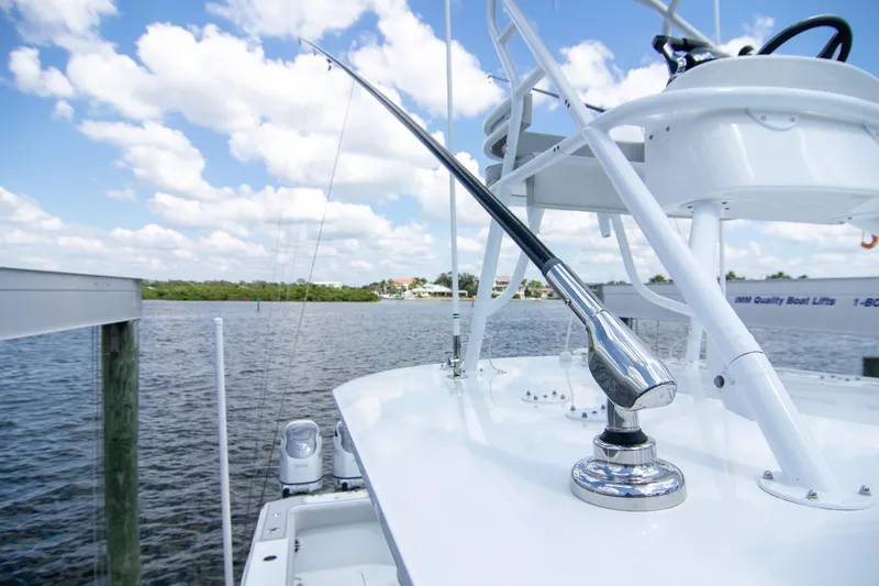 Slide: The Image of 2022 Freeman 37 VH boat with fishing rod holder, docked by a scenic waterfront. - 37