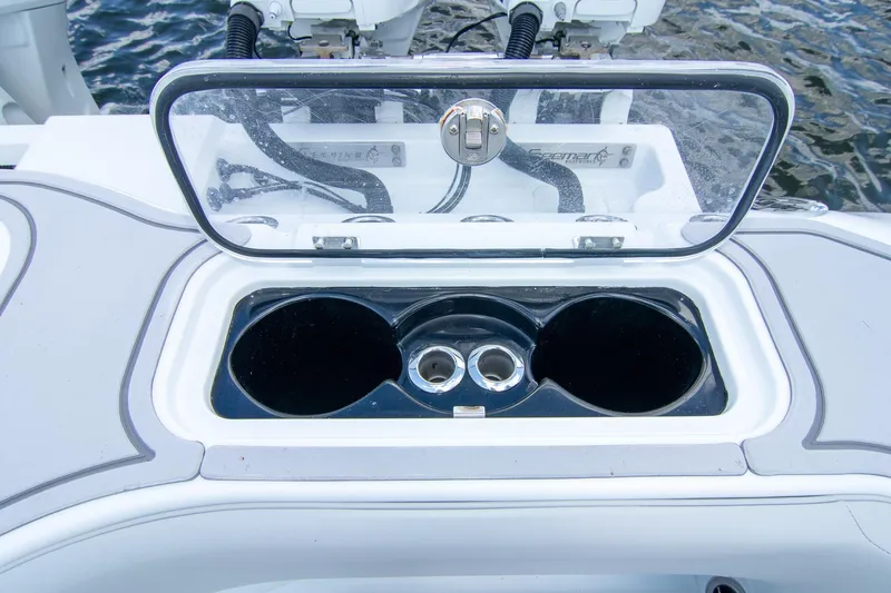 Slide: The Image of Open storage compartment on 2022 Freeman 37 VH boat, featuring cup holders and a clear lid. - 40