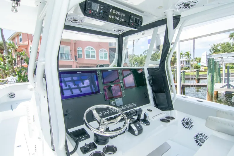 Slide: The Image of 2022 Freeman 37 VH boat cockpit with advanced navigation systems and steering wheel. - 9