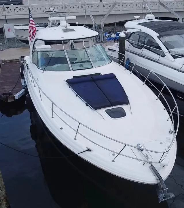 Slide: The Image of 2005 Sea Ray 420 Sundancer yacht docked at marina with American flag. - 10