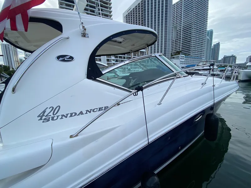 Slide: The Image of 2005 Sea Ray 420 Sundancer yacht docked in a marina. - 16