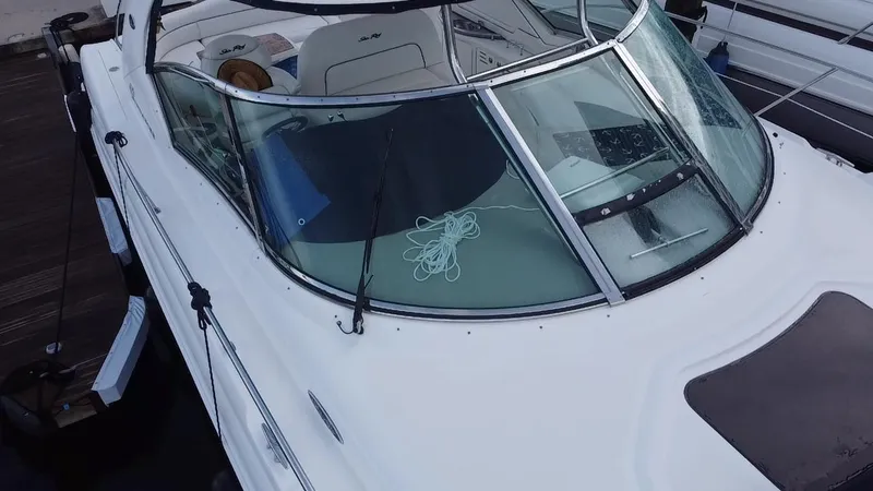 Slide: The Image of 2005 Sea Ray 420 Sundancer boat docked, view of the cockpit and windshield. - 17