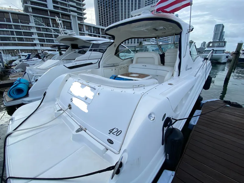 Slide: The Image of 2005 Sea Ray 420 Sundancer yacht docked at marina with city skyline. - 19