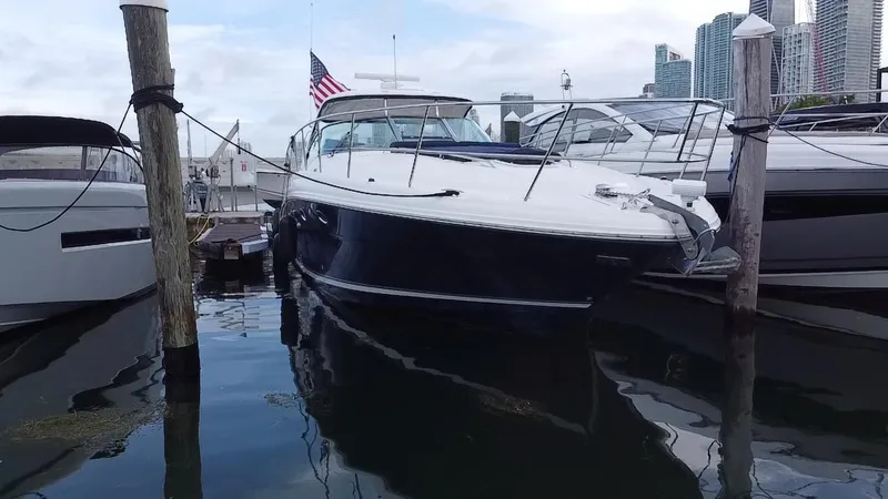 Slide: The Image of 2005 Sea Ray 420 Sundancer docked at marina with city skyline in background. - 3