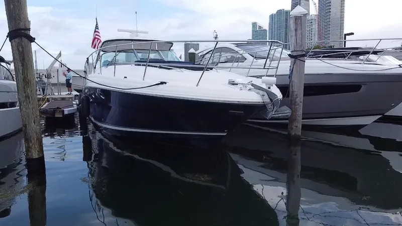 Slide: The Image of 2005 Sea Ray 420 Sundancer docked at marina with city skyline. - 4