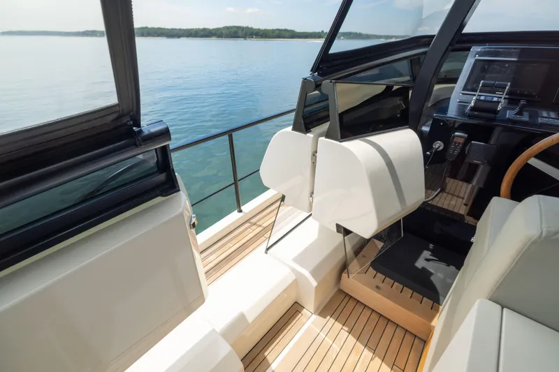 Slide: The Image of 2024 Sanlorenzo SL90A yacht cockpit with modern controls and sleek design on calm water. - 26