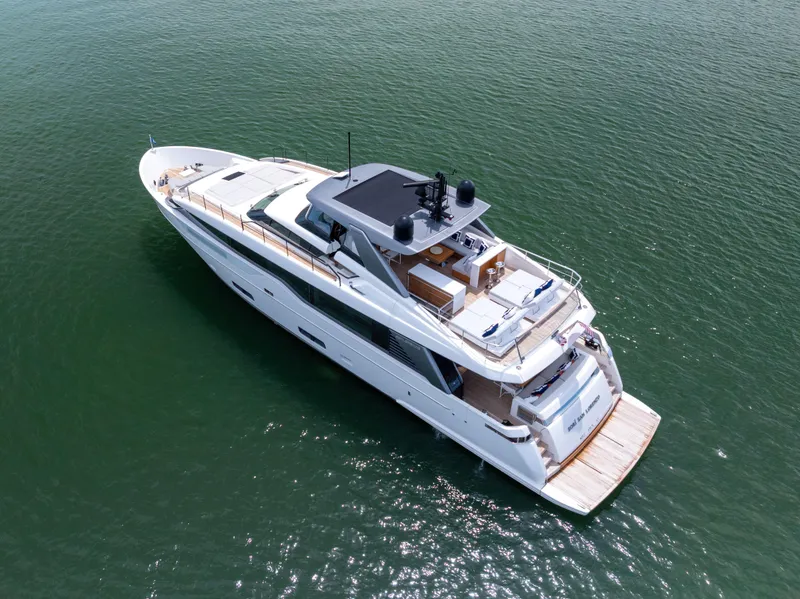 Slide: The Image of 2024 Sanlorenzo SL90A luxury yacht on calm green water, aerial view. - 7