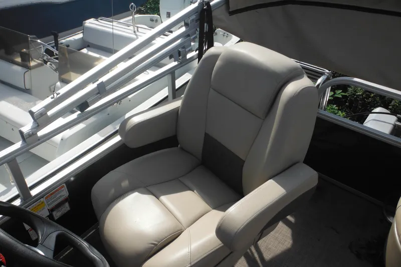 Slide: The Image of 2024 Sun Tracker Bass Buggy 16 XL Select pontoon boat interior with seating and console. - 11
