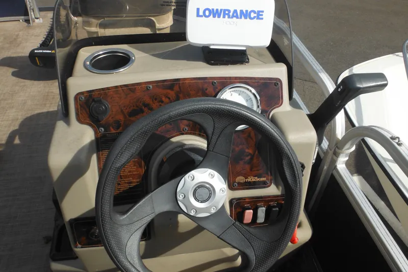 Slide: The Image of 2024 Sun Tracker Bass Buggy 16 XL Select boat seat, beige upholstery, outdoor setting. - 12