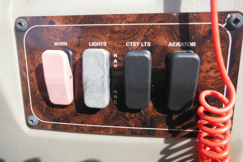 Slide: The Image of 2024 Sun Tracker Bass Buggy 16 XL Select dashboard with steering wheel and Lowrance display. - 13