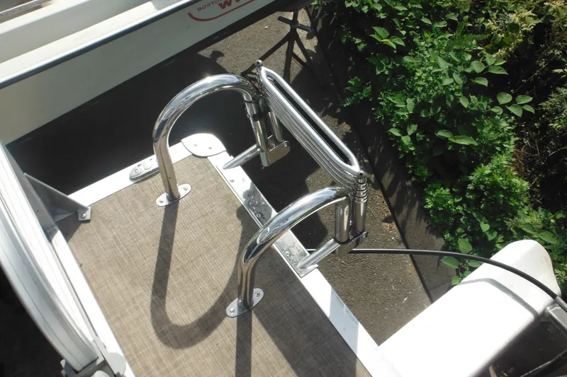 Slide: The Image of 2024 Sun Tracker Bass Buggy 16 XL Select with red fuel tank and beige seating. - 21