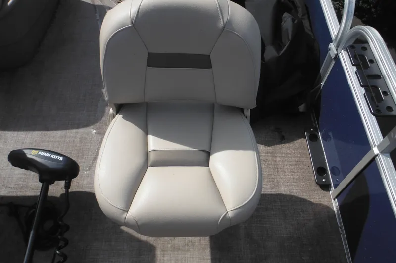 Slide: The Image of 2024 Sun Tracker Bass Buggy 16 XL Select boat console with beige seating and cup holders. - 26