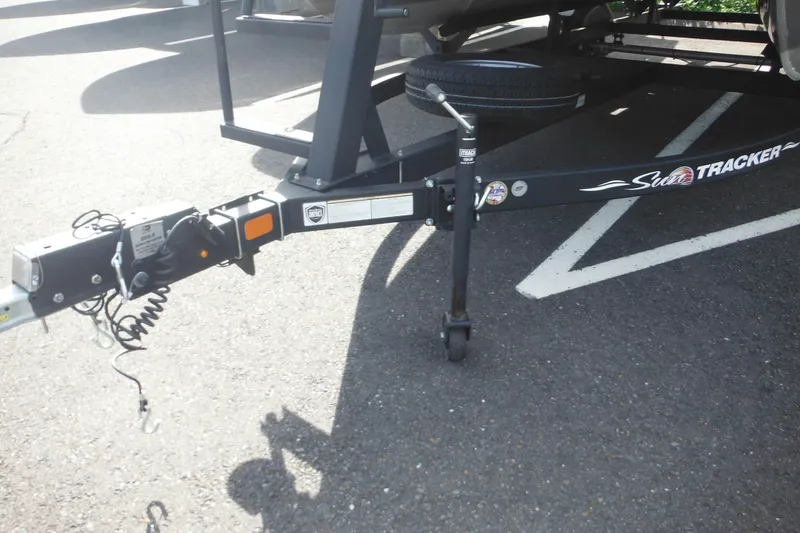 Slide: The Image of 2024 Sun Tracker Bass Buggy 16 XL Select pontoon boat on trailer in parking lot. - 3