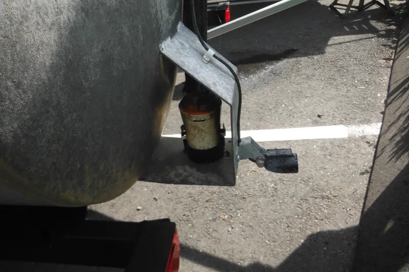 Slide: The Image of 2024 Sun Tracker Bass Buggy 16 XL Select with Mercury outboard motor in a lush outdoor setting. - 32