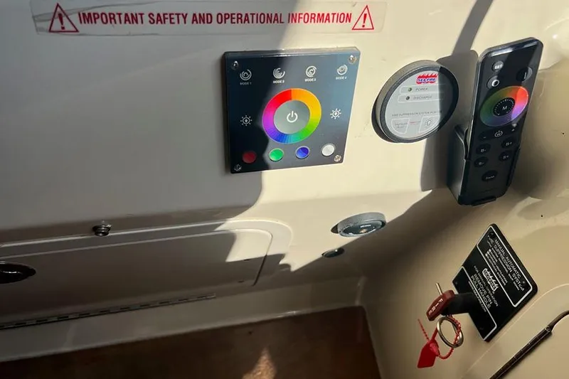 Slide: The Image of Control panel of a 2015 Sea Ray 470 Sundancer with safety information and remote. - 13
