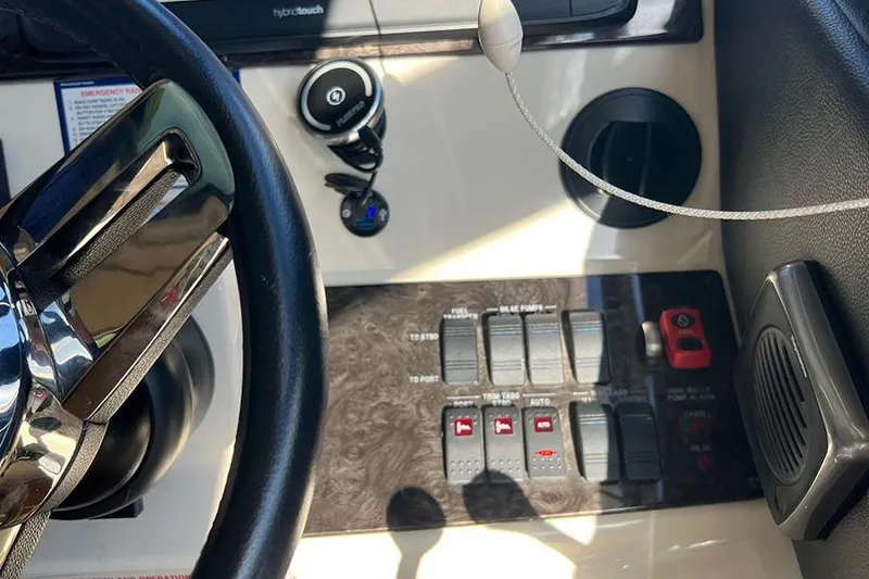 Slide: The Image of Control panel of a 2015 Sea Ray 470 Sundancer yacht with steering wheel and switches. - 16