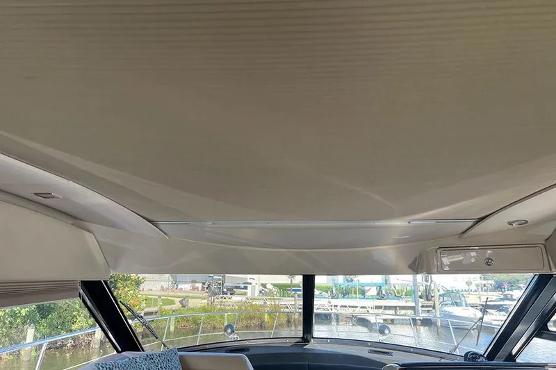 Slide: The Image of Interior view of 2015 Sea Ray 470 Sundancer yacht with large windows and sleek design. - 20