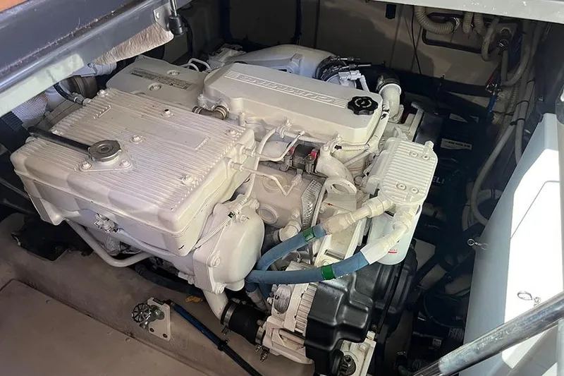 Slide: The Image of Engine compartment of a 2015 Sea Ray 470 Sundancer yacht, showcasing detailed machinery. - 21