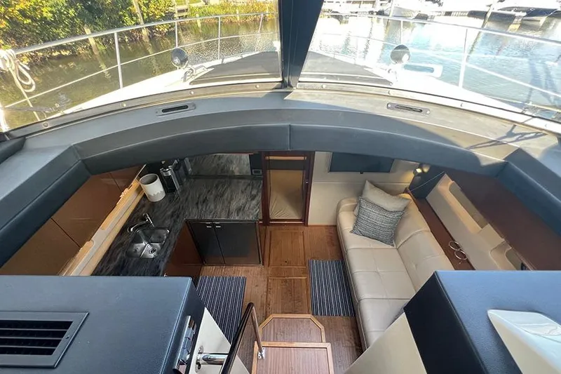 Slide: The Image of Interior of 2015 Sea Ray 470 Sundancer yacht with modern kitchen and seating area. - 24