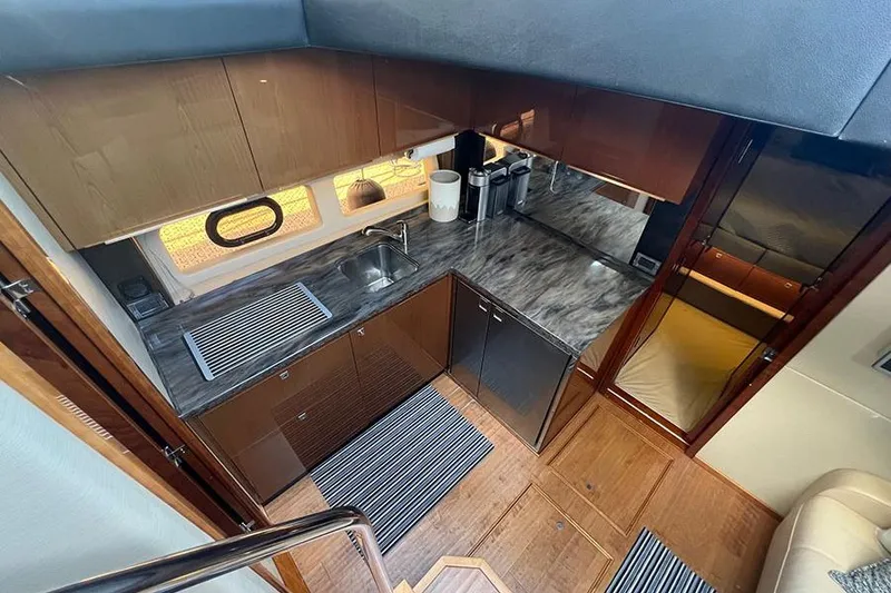 Slide: The Image of Luxurious kitchen interior of 2015 Sea Ray 470 Sundancer yacht with modern amenities. - 26