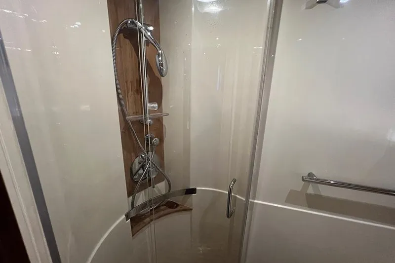 Slide: The Image of Shower area in 2015 Sea Ray 470 Sundancer yacht, featuring modern fixtures and glass door. - 31