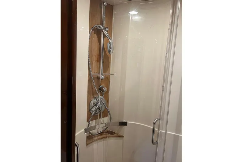 Slide: The Image of Shower area in 2015 Sea Ray 470 Sundancer yacht, featuring modern fixtures and glass doors. - 33