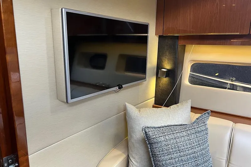 Slide: The Image of Interior of 2015 Sea Ray 470 Sundancer with TV, cushions, and window. - 35