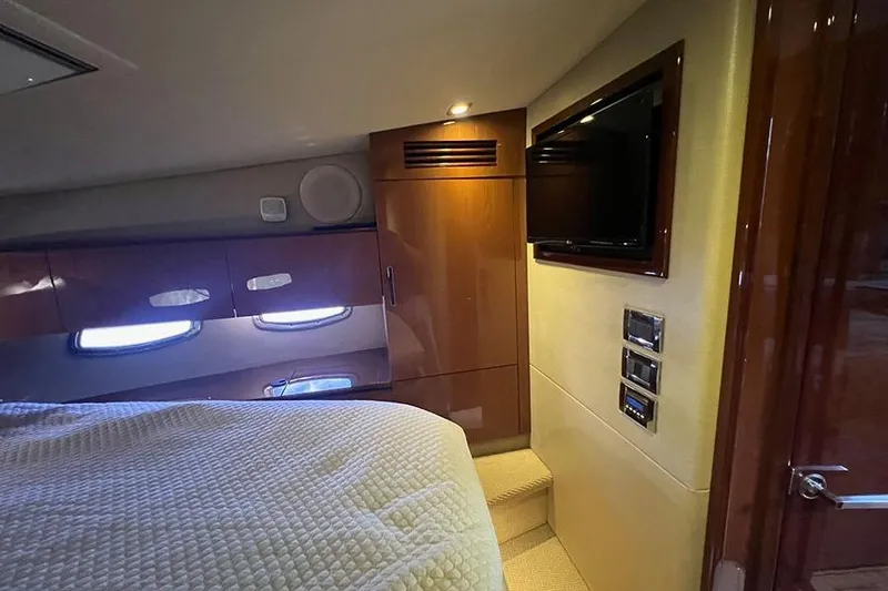 Slide: The Image of Luxurious cabin interior of 2015 Sea Ray 470 Sundancer yacht with TV and wood finishes. - 38