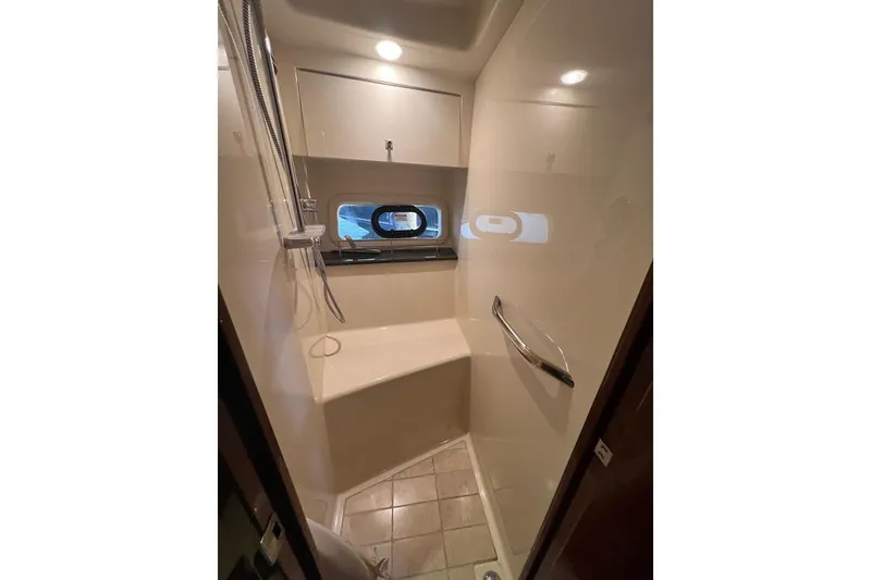 Slide: The Image of Shower area in 2015 Sea Ray 470 Sundancer yacht, featuring modern fixtures and a window. - 39