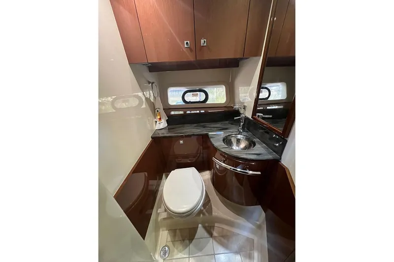 Slide: The Image of Luxurious bathroom in 2015 Sea Ray 470 Sundancer yacht with modern fixtures and wood cabinetry. - 40
