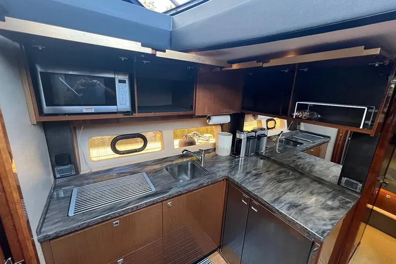 Slide: The Image of Luxurious kitchen interior of 2015 Sea Ray 470 Sundancer yacht with modern amenities. - 42