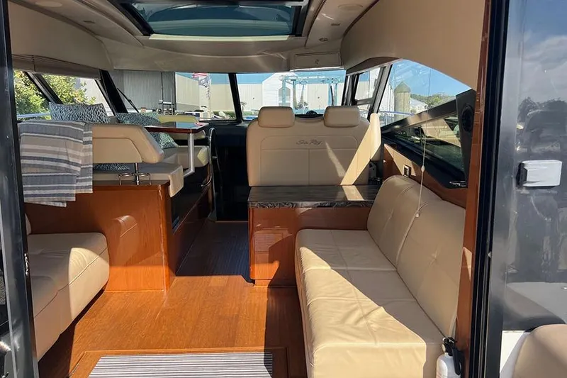 Slide: The Image of Interior of 2015 Sea Ray 470 Sundancer yacht with luxurious seating and wood finishes. - 7