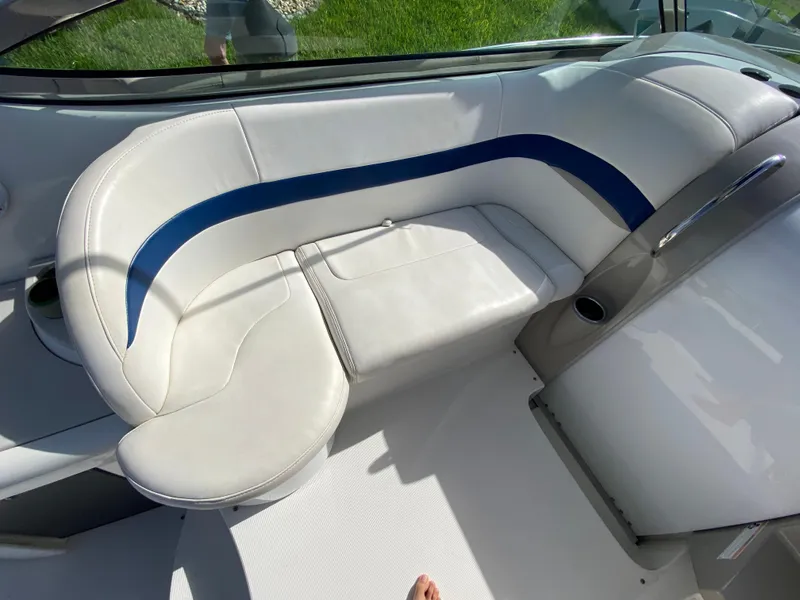 Slide: The Image of 2003 Formula 37PC boat interior with white and blue cushioned seating. - 17