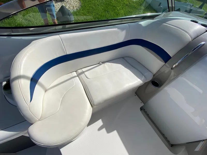 Slide: The Image of 2003 Formula 37PC boat interior with white and blue cushioned seating. - 18